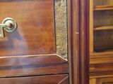 a close up of a wooden cabinet with drawers