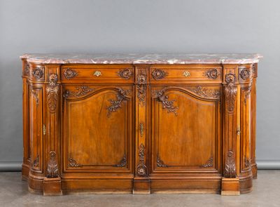 an old wooden sideboard with marble top