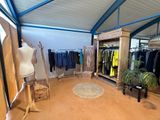 an image of a clothing store with a lot of clothes on display