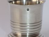 a silver cup that is sitting on a table