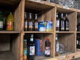 many bottles and glasses on the shelves in the room