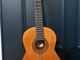 an acoustic guitar sitting on a wooden floor in front of a blue door