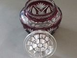 a glass jar with a lid sitting on a table next to a glass container