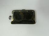 a small black purse that is on a white surface