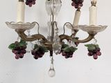 a chandelier with a bunch of grapes hanging from it