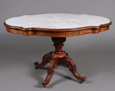 une table à plateau en marbre posée sur un piédestal avec un socle en bois