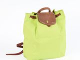 the backpack is green and brown with a brown handle