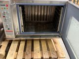a microwave that is sitting on a pallet in a warehouse