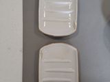 two white plates with gold rims sit on a table