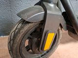 a scooter that is sitting on the floor next to a wall