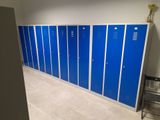many blue lockers in the hallway of a building