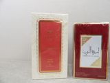 two boxes of perfume sitting next to each other on a table