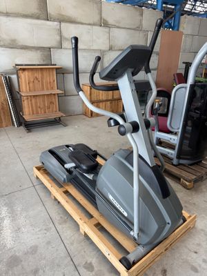 a stationary exercise bike in a garage with a pallet