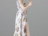 a figurine of a woman playing a flute