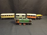 four toy trains that are lined up on a black surface