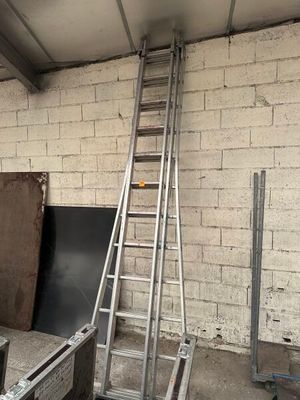 a ladder leaning up against a brick wall in a room
