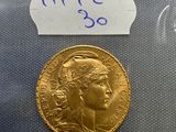 a close up of a gold coin with a label on it