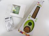 a small ukulee in the box next to it ' s packaging