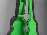 a guitar case with a green interior sitting on a table