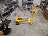 a yellow hand truck in a warehouse with lots of boxes