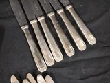 five knives and six knives on a black cloth