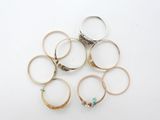 several different rings are arranged in a circle on a white surface