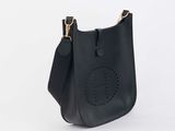 a black leather bag with a peace sign on the front