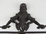 a statue of a woman holding a sword on a pole