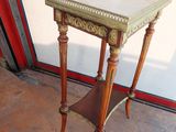 a small wooden table with a glass top on it