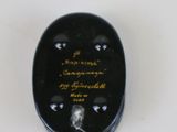 a small black object with writing on it