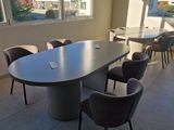 tables and chairs in a room with large windows overlooking a city