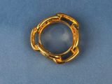 a close up of a gold ring on a blue surface