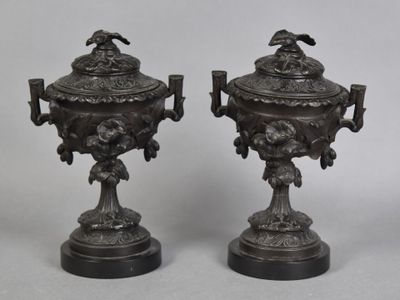 pair of antique bronze urns with birds and flowers on them