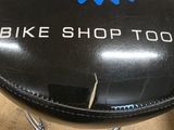 a black stool with a blue and white logo on it