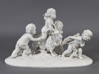 a figurine of a group of children playing with a goat
