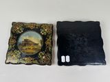 two pieces of black and gold with a picture of a building on it