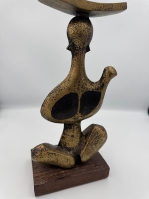 brass figurine of a duck with a hat on its head