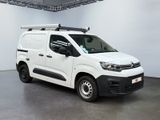 the white van is parked in a large room with a roof rack