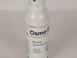 a close up of a bottle of osmo on a white surface