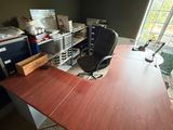 a desk with a chair and a computer on it in a room