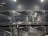 a room with a lot of cages and pallets on the floor