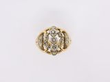 a close up of a gold and diamond ring on a white background