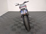 a motorcycle that is parked in a room with a checkered floor