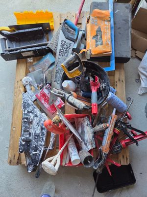 a pile of tools on a pallet on the floor