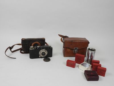 two cameras and a case on a white surface