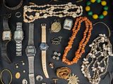 many different types of jewelry laid out on the table