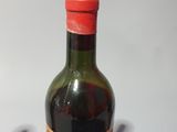 a bottle of wine sitting on a table next to a bottle of wine