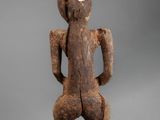 an old wooden statue of a man with a hat on his head