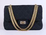 a black quilted shoulder bag with gold chain