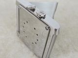 a silver lighter that is sitting on a table